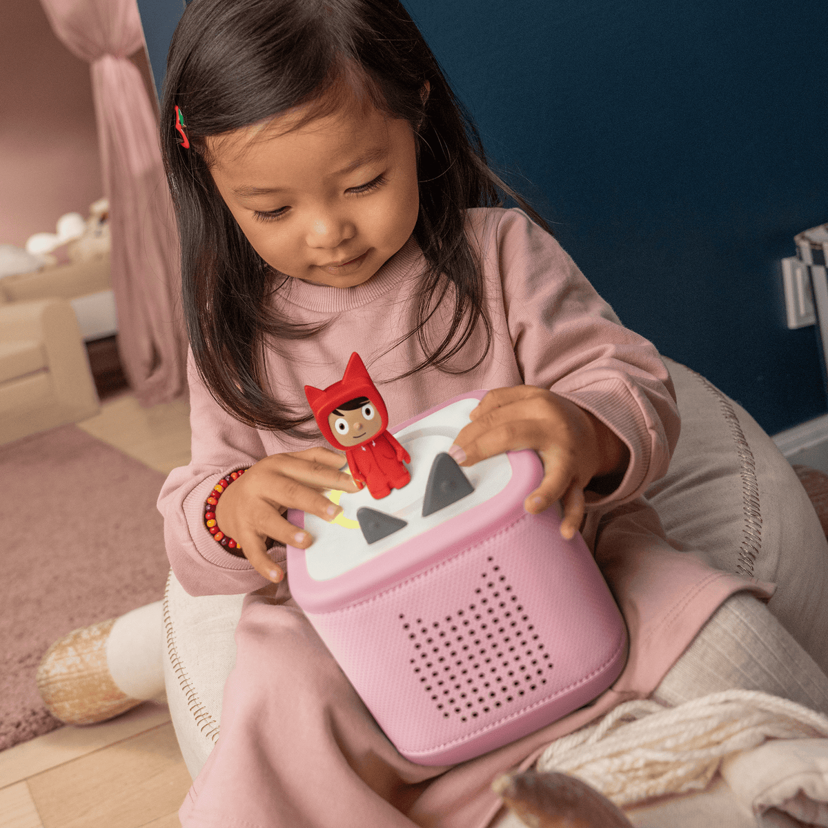 child playing with red creative-tonie on a toniebox 2, an audio player for kids