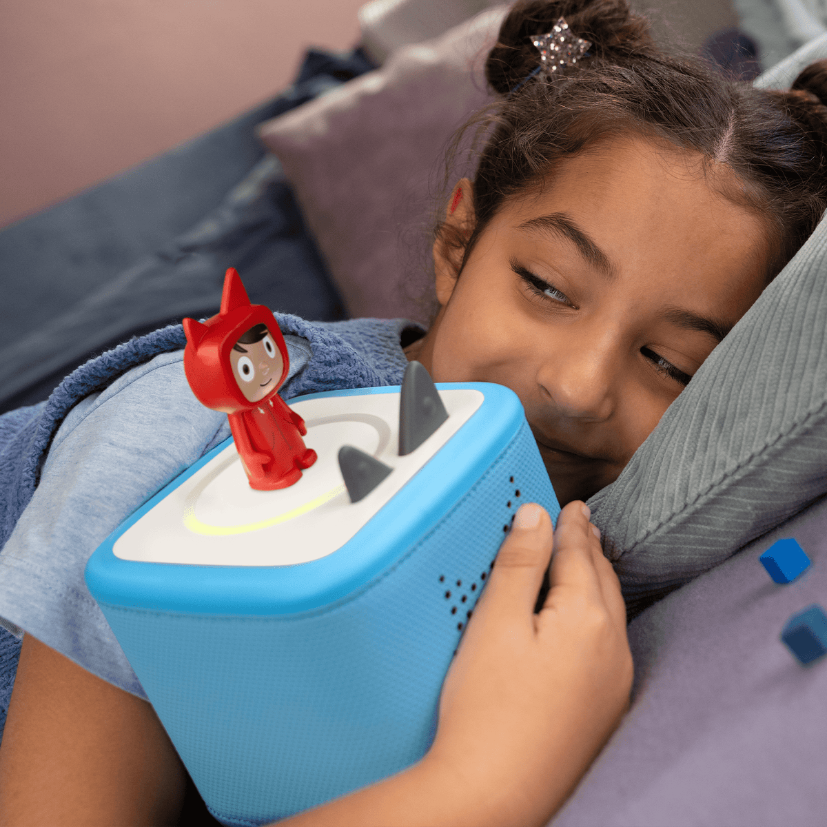 child playing with red creative-tonie on a toniebox 2, an audio player for kids