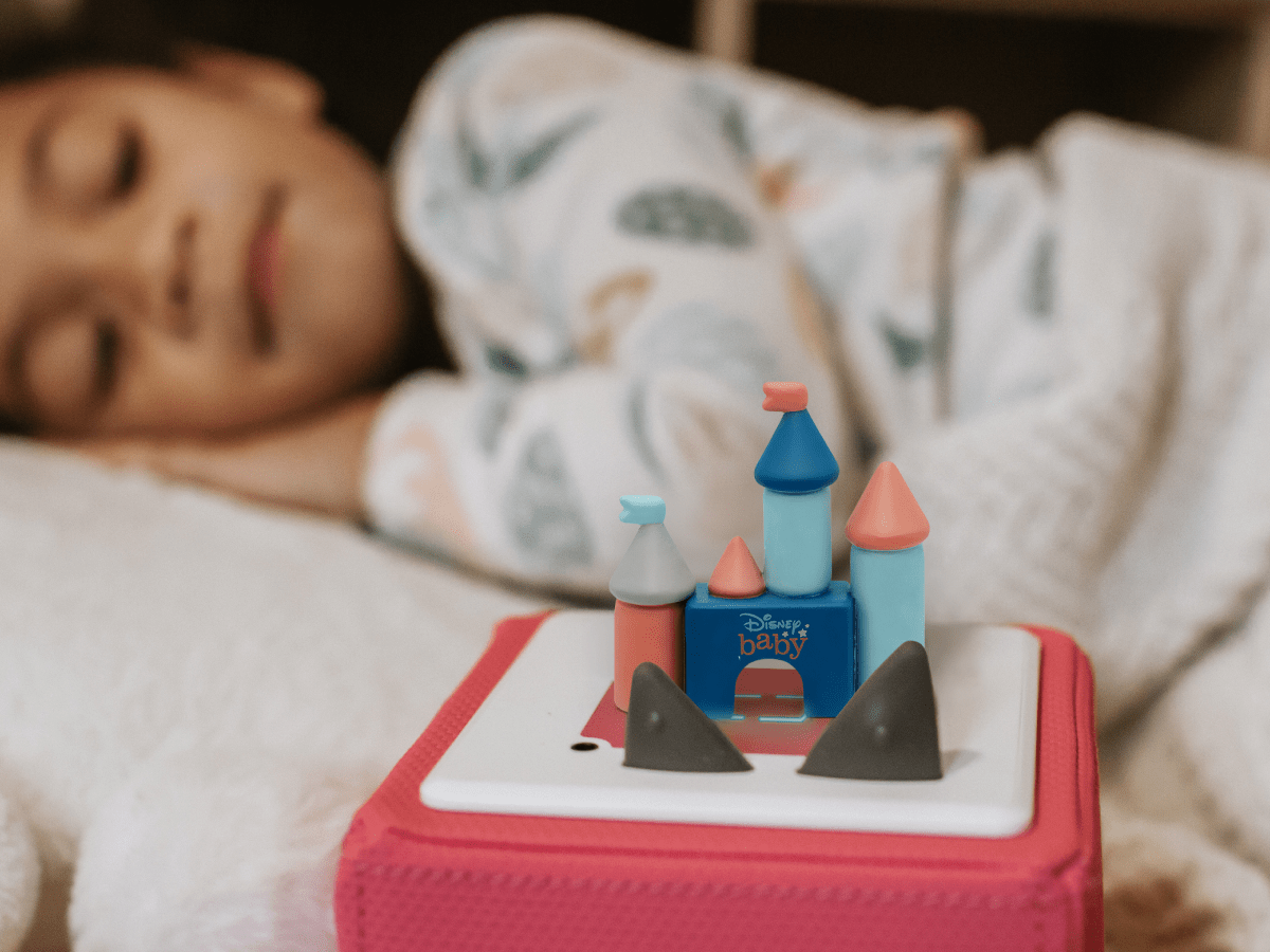 Child playing with Disney Baby Lullabies Tonie audio figurine and Toniebox 2